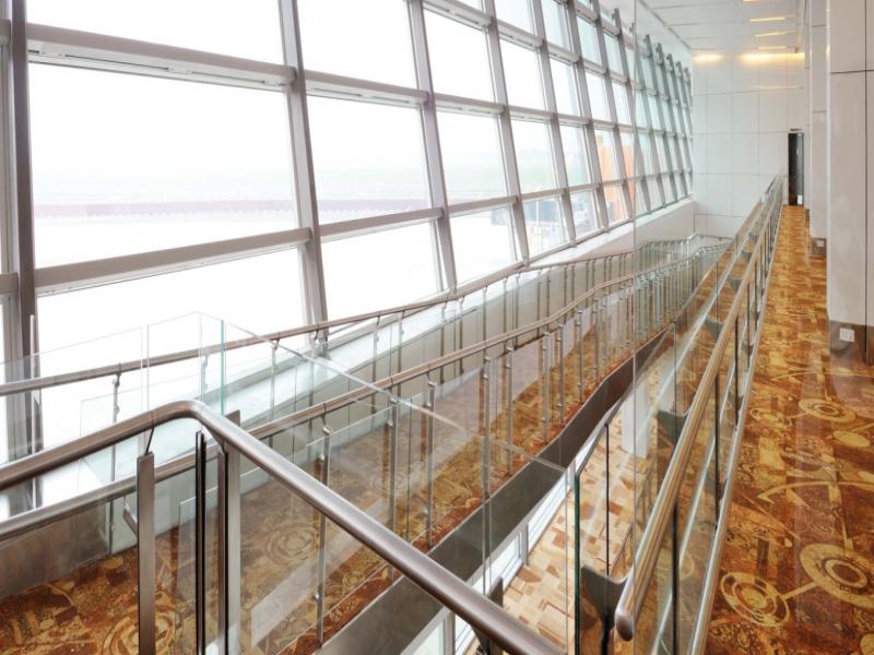 Stainless steel top Handrail connected with offset stems to stainless steel flat balustrade with ofset holders supporting 10mm glass. This also has in-built Skirt rail.